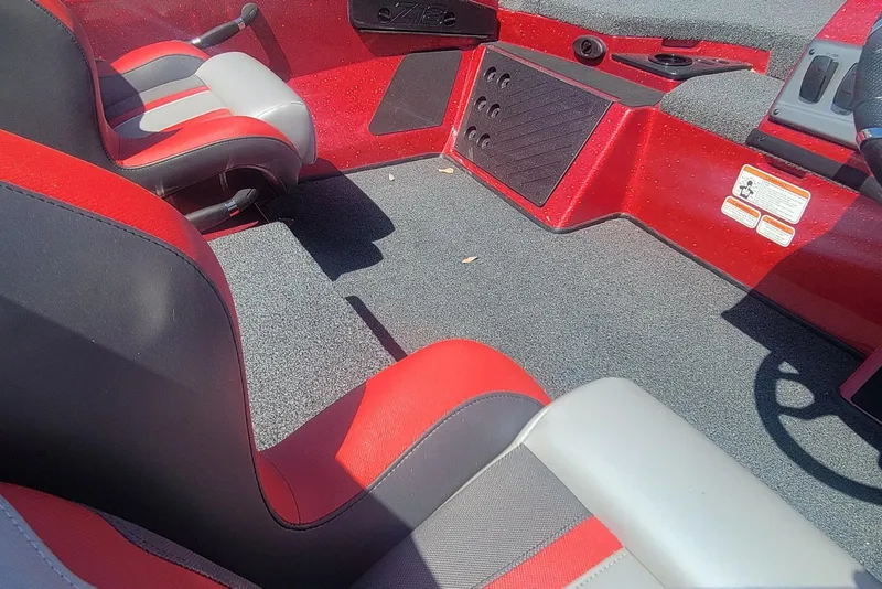 Slide: The Image of Interior of 2026 Nitro Z18 boat with red and gray seating and carpeted floor. - 17
