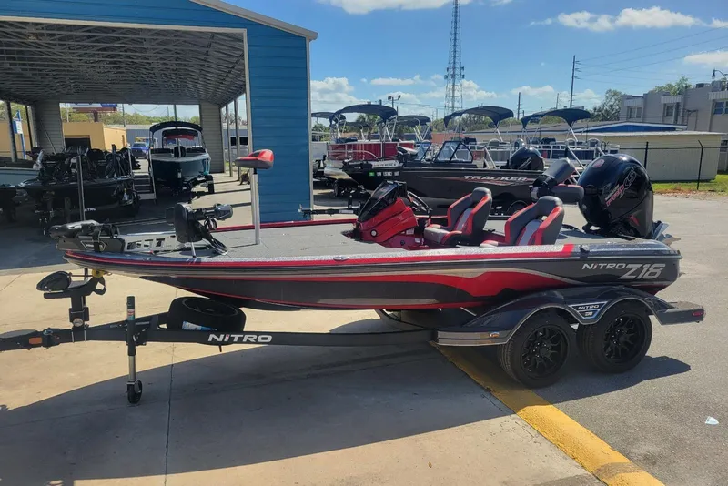 Slide: The Image of 2026 Nitro Z18 boat with trailer, parked outdoors at a dealership. - 4