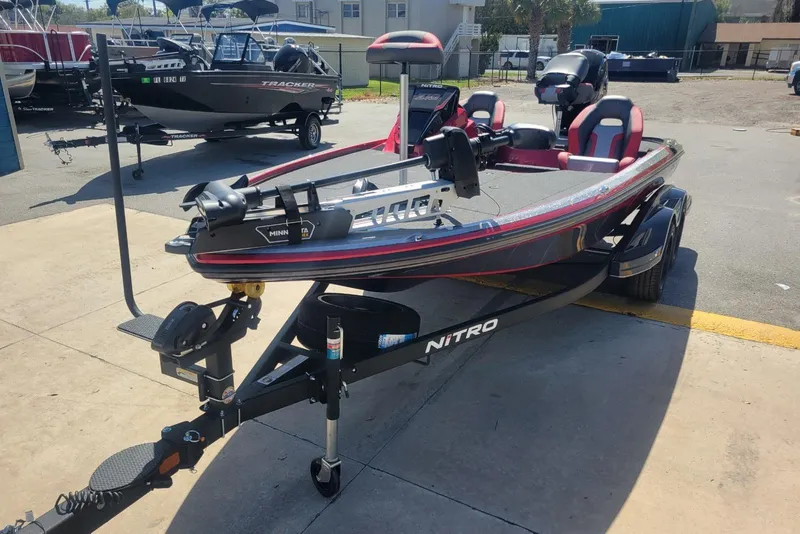 Slide: The Image of 2026 Nitro Z18 boat on trailer, parked outdoors, featuring Minn Kota trolling motor. - 5