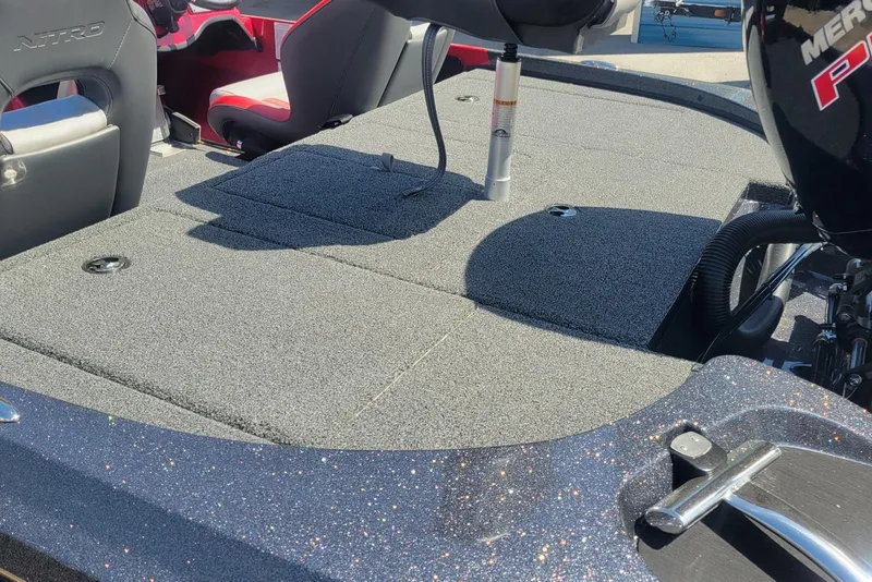 Slide: The Image of 2026 Nitro Z18 boat interior with carpeted deck and seating. - 7