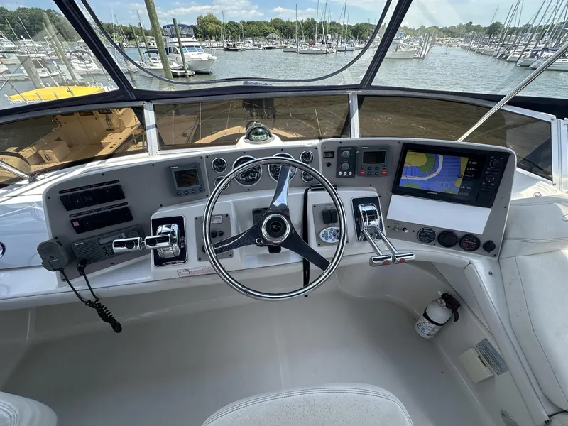 Slide: The Image of Cockpit of 2002 Regal 3880 yacht with steering wheel and navigation equipment. - 11