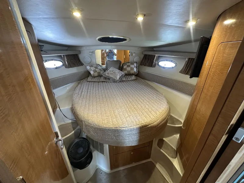 Slide: The Image of Cozy cabin interior of 2002 Regal 3880 yacht with round bed and wooden accents. - 13