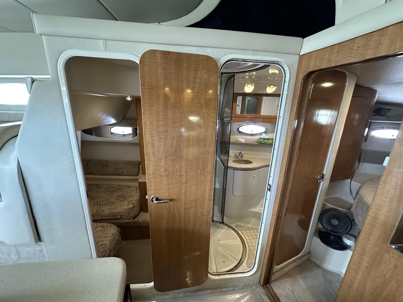 Slide: The Image of Interior of 2002 Regal 3880 yacht featuring bathroom and cabin with wood finishes. - 15