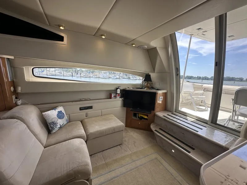 Slide: The Image of Luxurious interior of a 2002 Regal 3880 yacht with plush seating and scenic window views. - 24