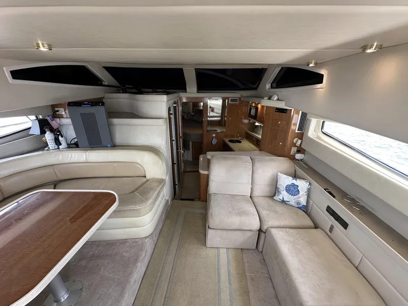 Slide: The Image of Interior of 2002 Regal 3880 yacht with beige seating and wooden accents. - 25
