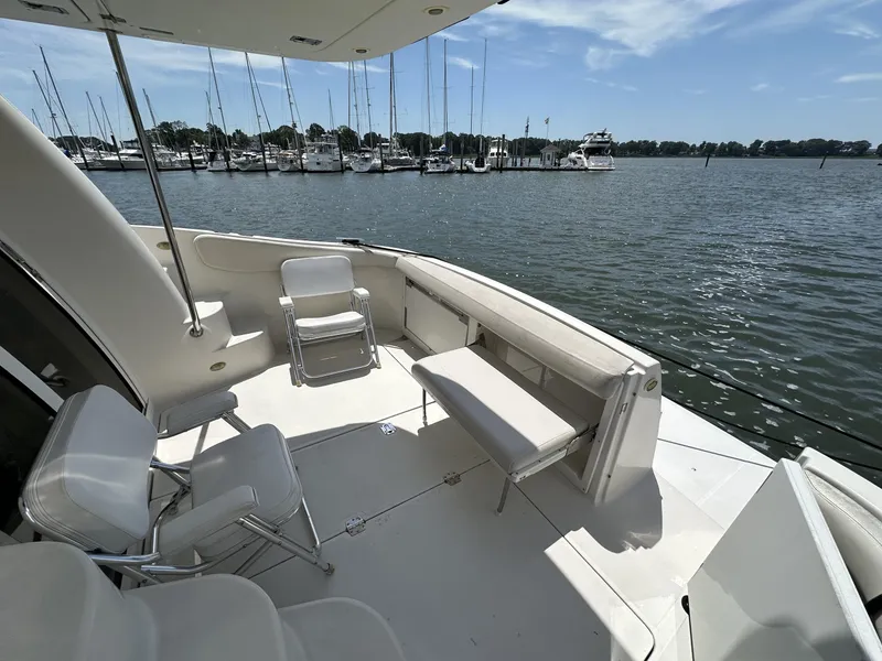 Slide: The Image of 2002 Regal 3880 yacht deck with seating, overlooking marina and calm waters. - 4