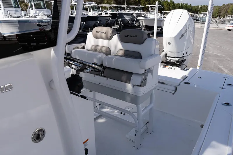 Slide: The Image of 2026 Caymas 26 HB boat interior with dual seats and Mercury outboard engine. - 12
