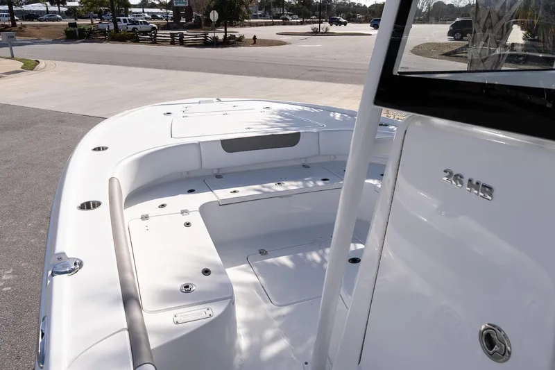 Slide: The Image of 2026 Caymas 26 HB boat deck, sleek design, spacious layout, parked outdoors. - 15