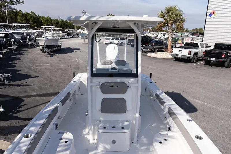 Slide: The Image of 2026 Caymas 26 HB boat in a dealership lot, showcasing sleek design and spacious deck. - 17