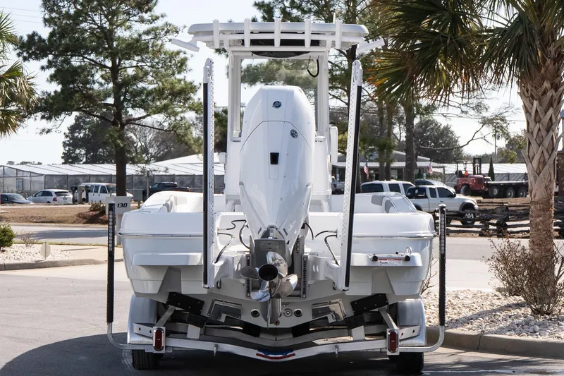 Slide: The Image of 2026 Caymas 26 HB boat rear view in a sunny outdoor setting. - 5