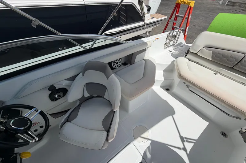 Slide: The Image of Interior view of a Four Winns HD3 boat, featuring seating and steering wheel. - 10