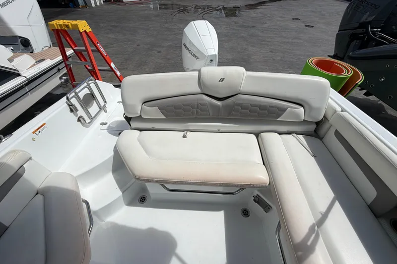 Slide: The Image of Four Winns HD3 boat interior with white cushioned seating and outboard motor. - 11