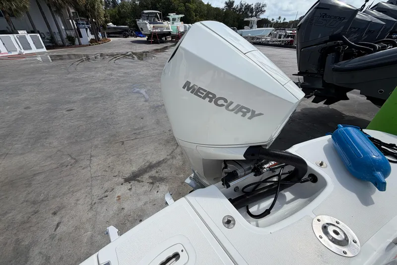 Slide: The Image of Outboard motor on Four Winns HD3 boat, parked in marina with other boats. - 12