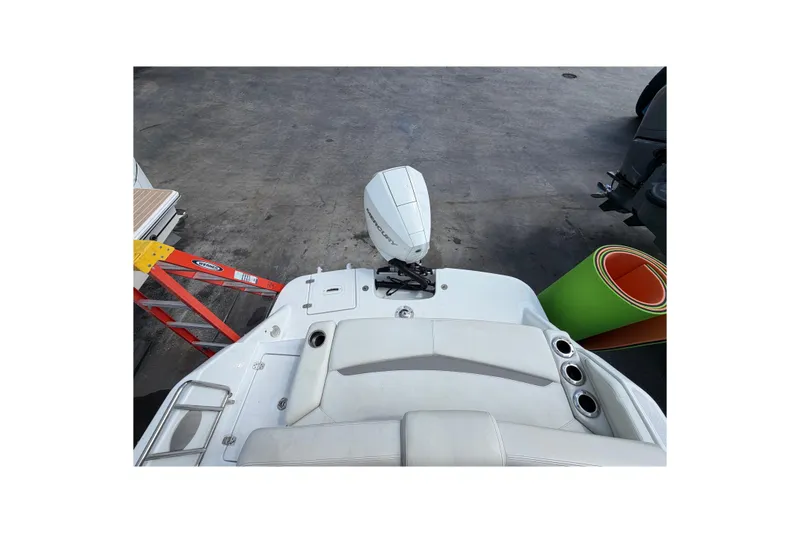 Slide: The Image of Four Winns HD3 boat stern view with outboard motor and dock ladder. - 14