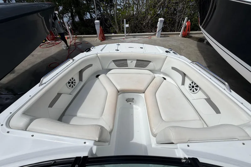 Slide: The Image of Bow seating area of Four Winns HD3 boat with white upholstery and speakers. - 15