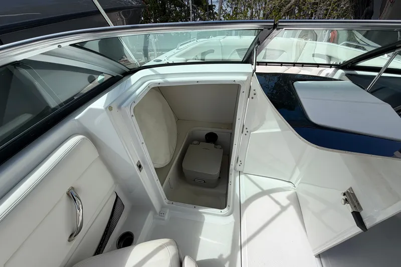 Slide: The Image of Four Winns HD3 boat interior with open storage compartment and seating area. - 16