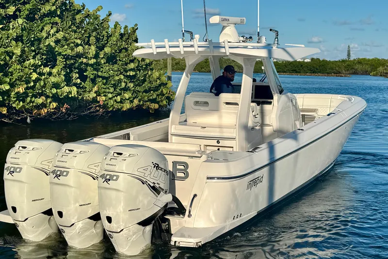 Slide: The Image of 2020 Intrepid 375 Nomad SE boat with triple Mercury 400R engines on calm water. - 10