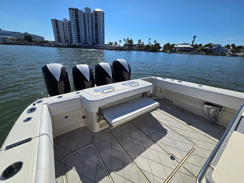 Slide: The Image of HCB 42 Siesta 2018 boat with four engines on calm water. - 14
