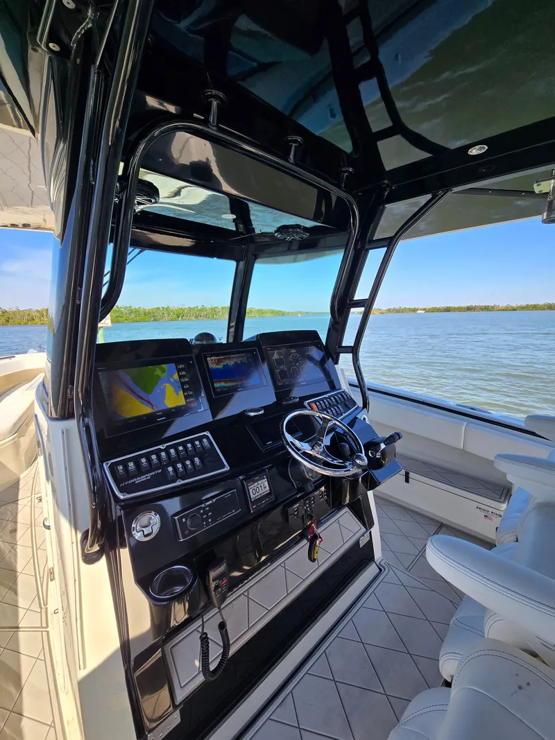 Slide: The Image of 2018 HCB 42 Siesta boat cockpit with navigation screens. - 19