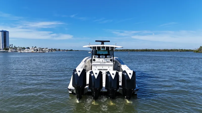 Slide: The Image of HCB 42 Siesta 2018 boat on calm water with blue sky. - 2