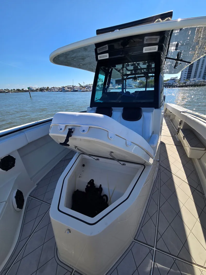 Slide: The Image of 2018 HCB 42 Siesta boat with open storage on water. - 31