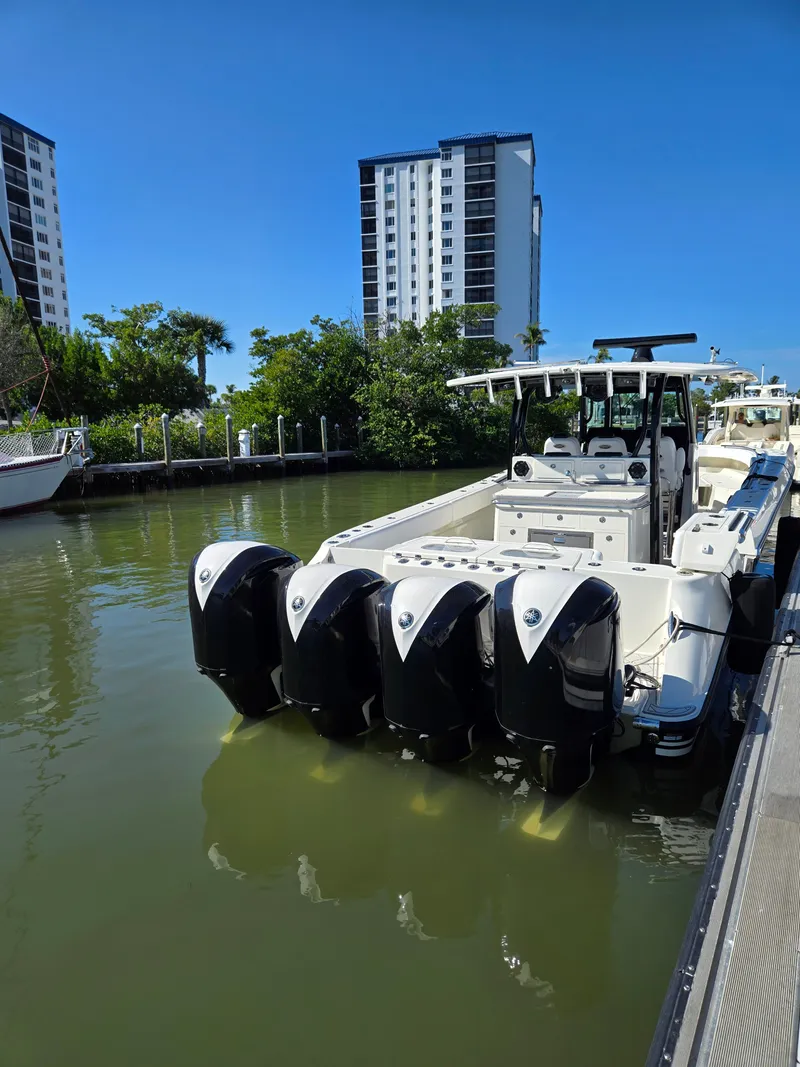 Slide: The Image of 2018 HCB 42 Siesta boat with four outboard engines docked. - 45