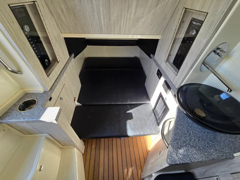 Slide: The Image of Interior of 2018 HCB 42 Siesta with sleeping area and wood paneling. - 5