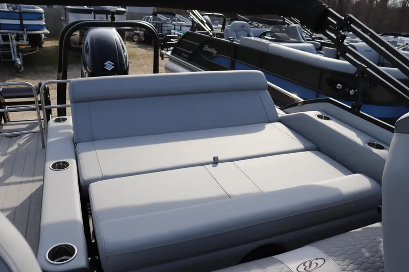 Slide: The Image of 2026 Bentley Pontoons Elite 223 SwingBack DC with luxurious seating and cup holders. - 9