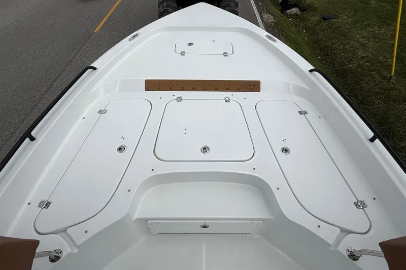 Slide: The Image of 2026 Sea Hunt BX 25 FS boat deck with storage compartments and ruler. - 18