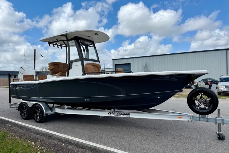 Slide: The Image of 2026 Sea Hunt BX 25 FS boat on trailer, parked outdoors under cloudy sky. - 5