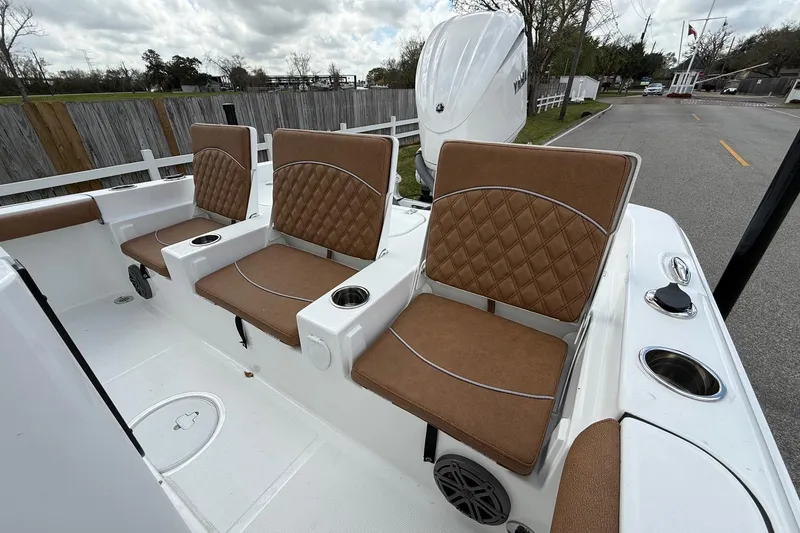 Slide: The Image of 2026 Sea Hunt BX 25 FS boat with brown cushioned seats and cup holders. - 7