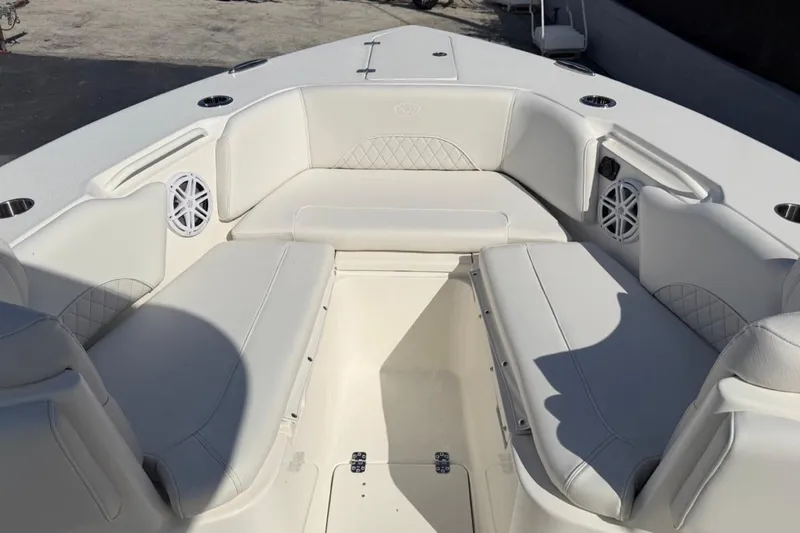 Slide: The Image of 2026 Key West 263 FS boat interior with white cushioned seating and built-in speakers. - 15