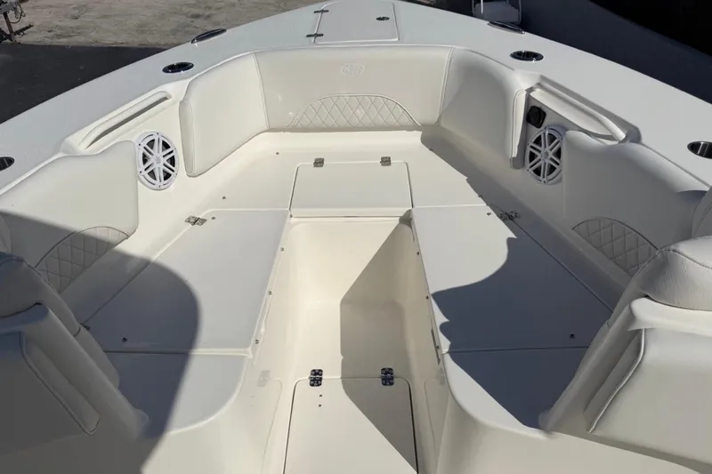 Slide: The Image of 2026 Key West 263 FS boat interior with white seating and built-in speakers. - 16