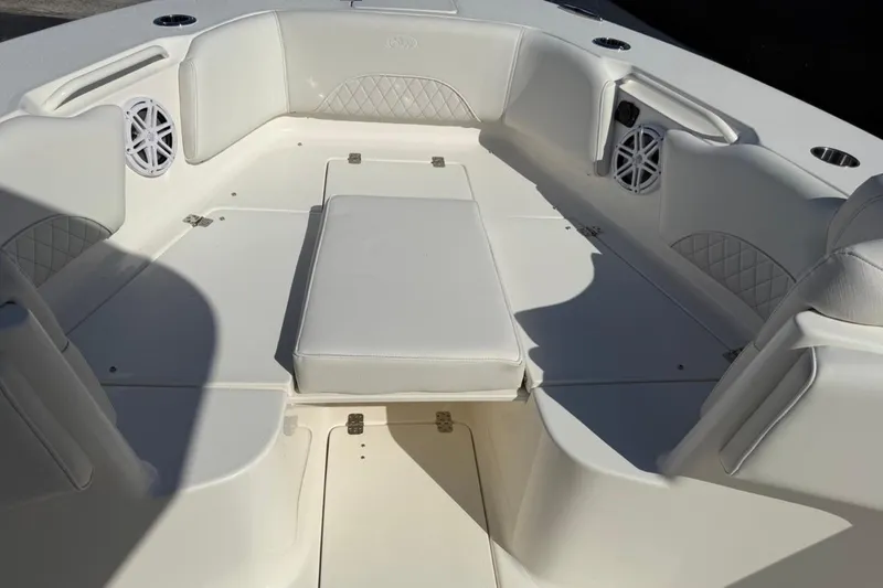 Slide: The Image of 2026 Key West 263 FS boat interior with white cushioned seating and speakers. - 17