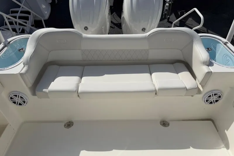 Slide: The Image of 2026 Key West 263 FS boat with cushioned seating and integrated speakers. - 21