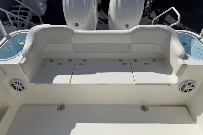 Slide: The Image of 2026 Key West 263 FS boat seating area with storage compartments and speakers. - 22