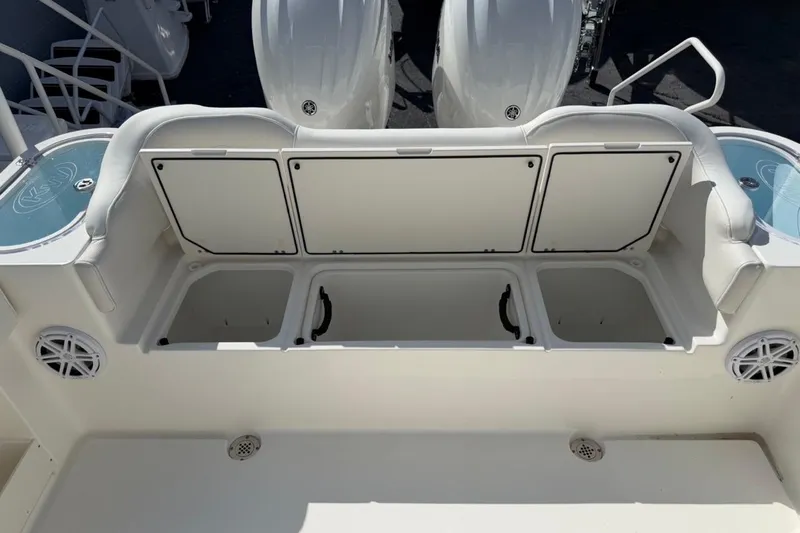 Slide: The Image of 2026 Key West 263 FS boat with open storage compartments and seating area. - 23