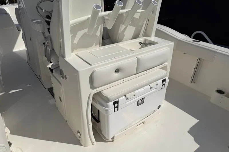 Slide: The Image of 2026 Key West 263 FS boat interior with rod holders, sink, and cooler. - 25
