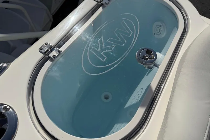 Slide: The Image of Livewell on 2026 Key West 263 FS boat, featuring KW logo and stainless steel hardware. - 29