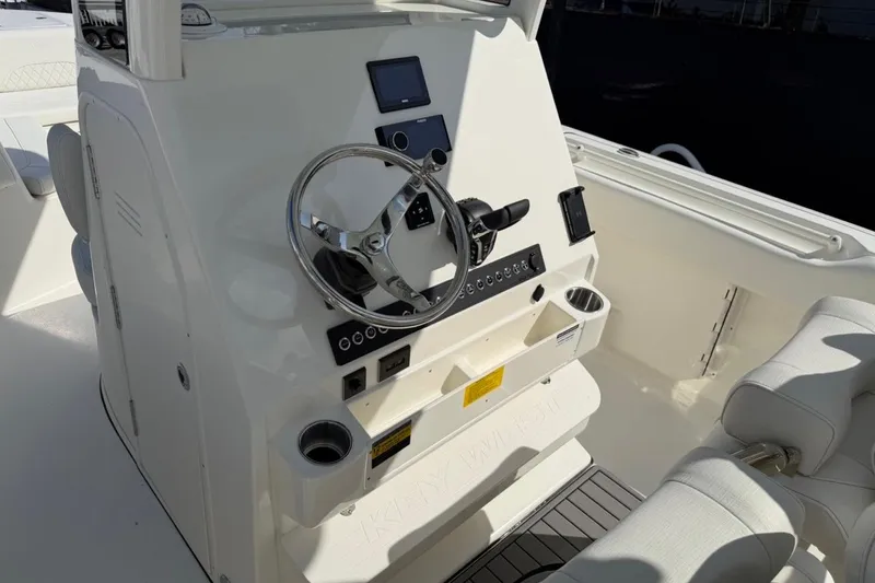Slide: The Image of 2026 Key West 263 FS boat helm with steering wheel and control panel. - 31