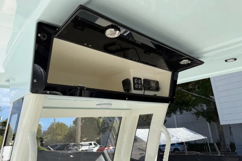 Slide: The Image of 2026 Key West 263 FS boat console with electronic controls and storage compartment. - 33