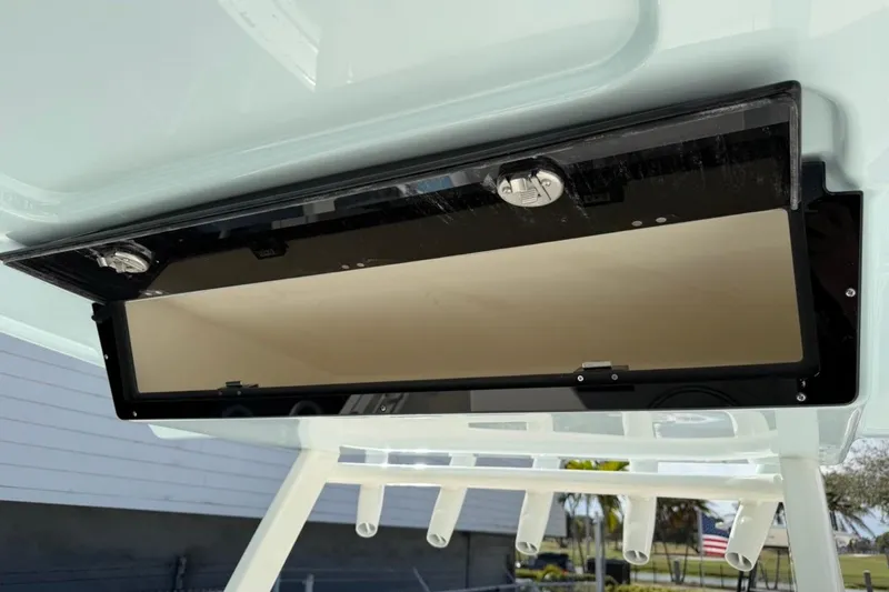 Slide: The Image of 2026 Key West 263 FS boat storage compartment with open lid, showcasing interior space. - 35