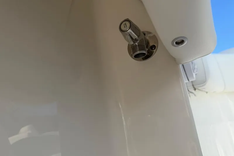 Slide: The Image of Close-up of a 2026 Key West 263 FS boat fitting against a clear blue sky. - 48