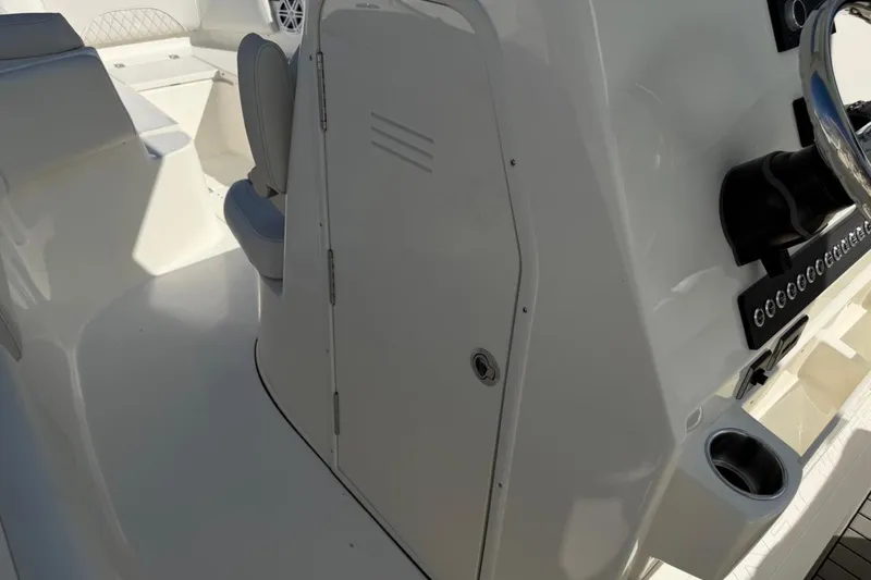 Slide: The Image of 2026 Key West 263 FS boat interior with seating and control panel. - 49