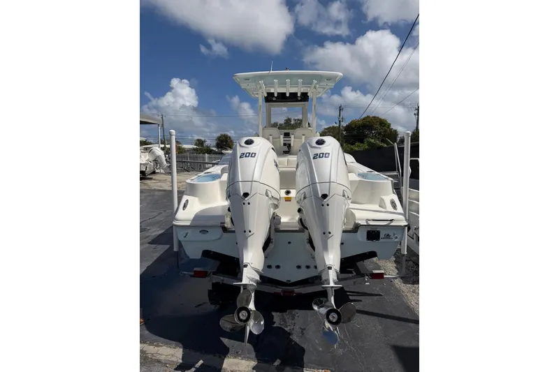 Slide: The Image of 2026 Key West 263 FS boat with dual 200 horsepower engines, docked under a clear sky. - 5