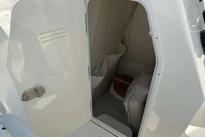 Slide: The Image of 2026 Key West 263 FS boat interior showing compact storage compartment. - 50