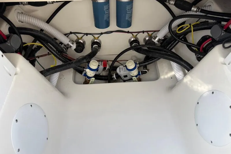 Slide: The Image of Engine compartment of 2026 Key West 263 FS boat, showcasing hoses and components. - 51