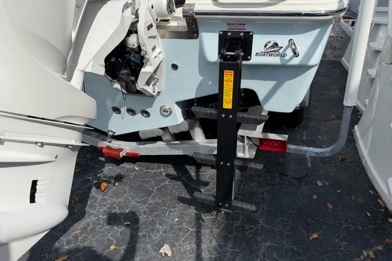 Slide: The Image of 2026 Key West 263 FS boat stern with motor and ladder on display. - 8