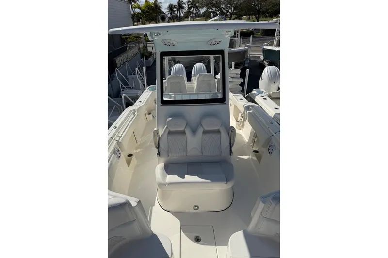Slide: The Image of 2026 Key West 263 FS boat interior with seating and console, docked outdoors. - 9