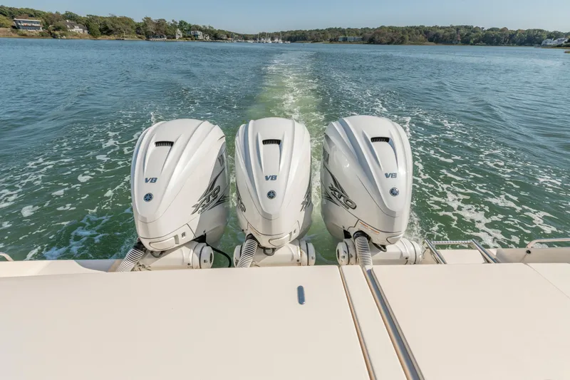 Slide: The Image of 2019 Grady-White Freedom 375 boat with triple V8 outboard engines on water. - 10